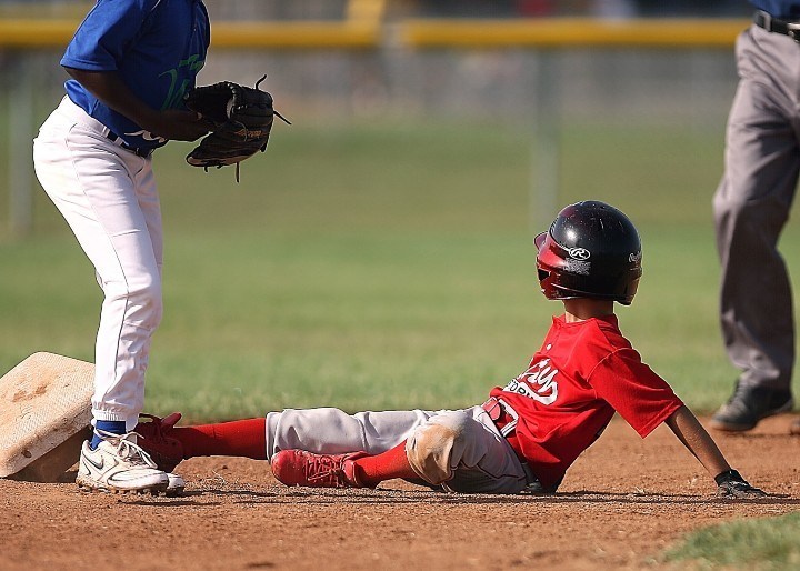 boy sliding into base during a baseball game